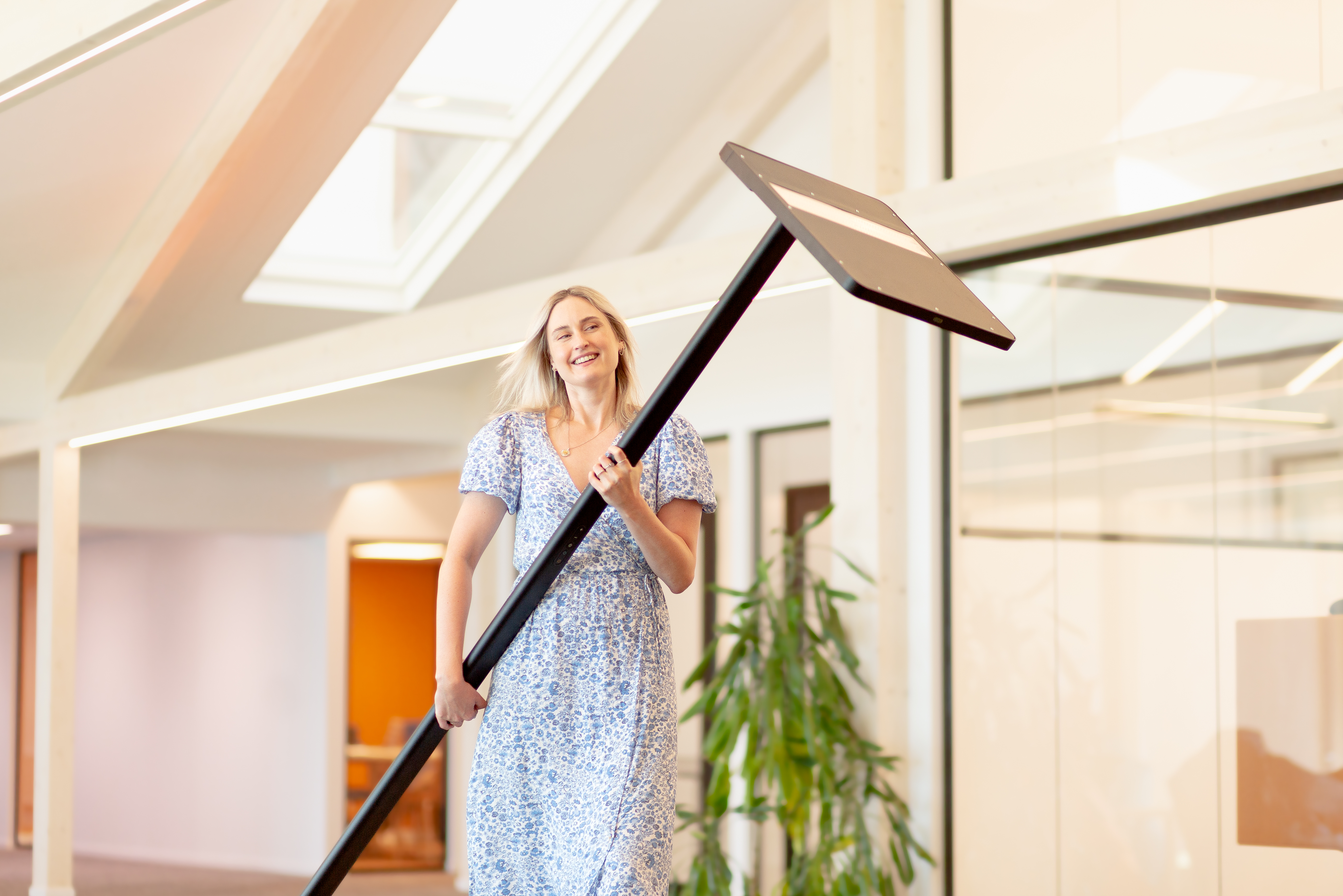 Woman carrying floor standing luminaire