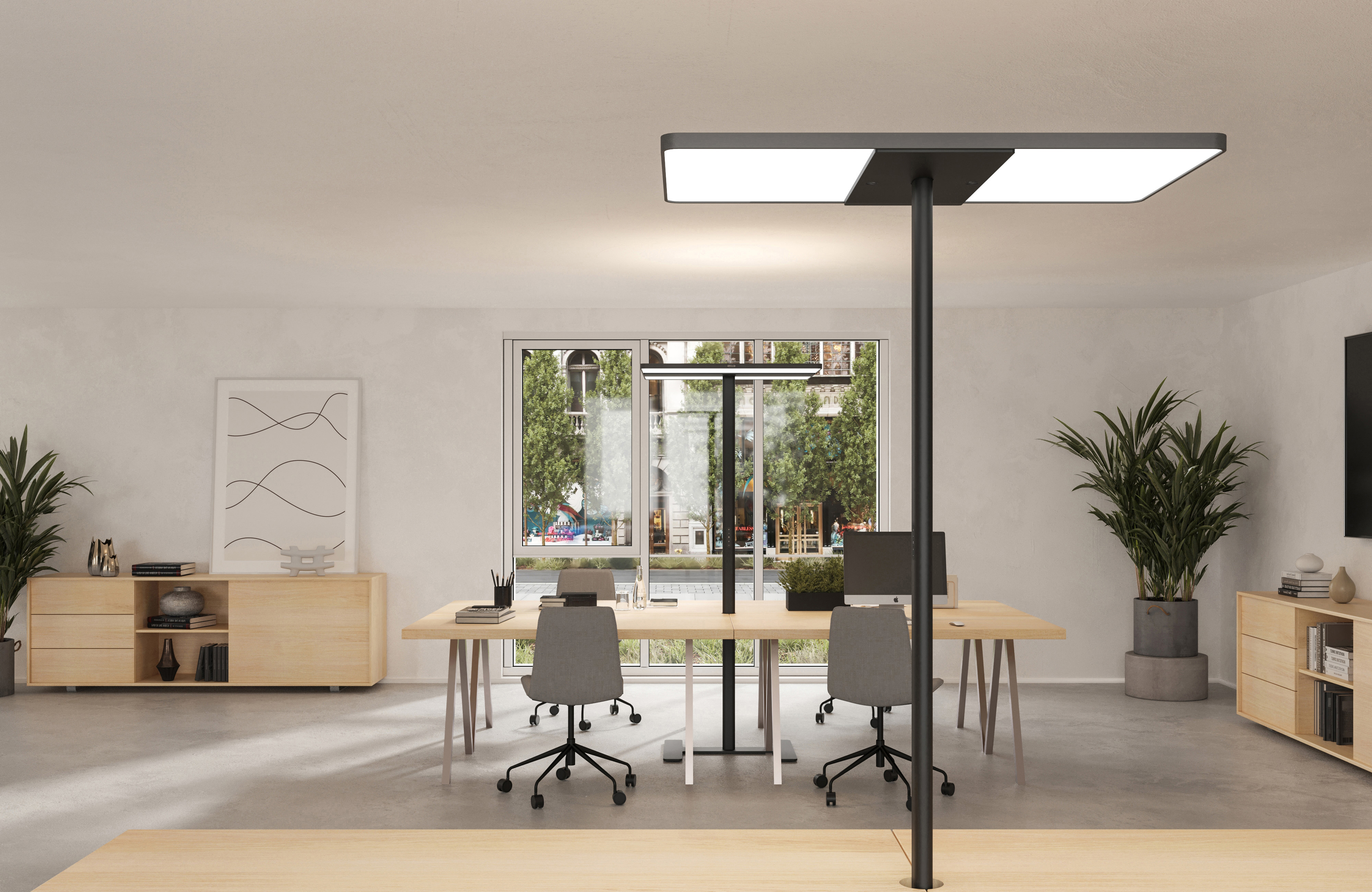 Black floor standing luminaires standing beside desks